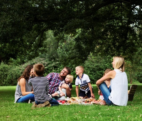 Couple and children enjoying picnic outside